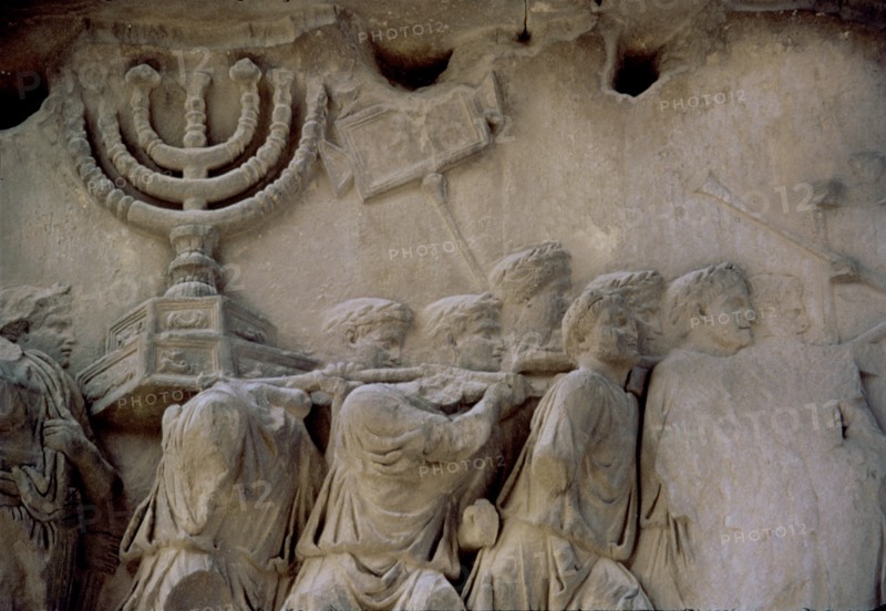 Basrelief in the Arch of Titus representing men carrying a menorah, located in the Via Sacra of t?