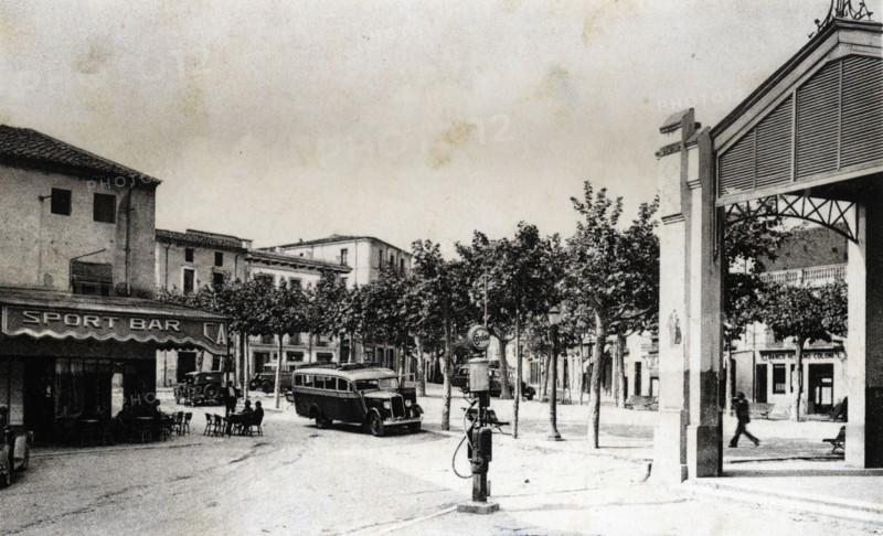 Regular bus at the stop of the bar Sport in Santa Coloma de Farners (Girona), on a postcard from ?