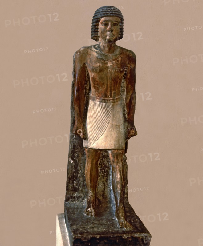 Hieratic statue of a man, made in polychromed limestone.