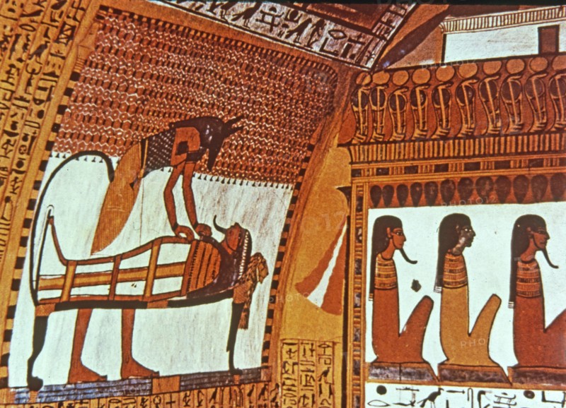 God Anubis mummifying a deceased, fresco in the tomb of Sennutem.
