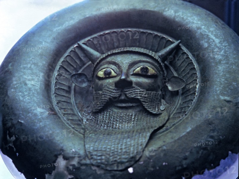 Mask of a river divinity, in bronze.