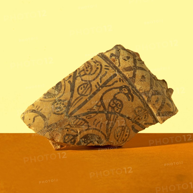 Basil collector, fragment decorated with pomegranates, with a bird resting on a branch. It belong?
