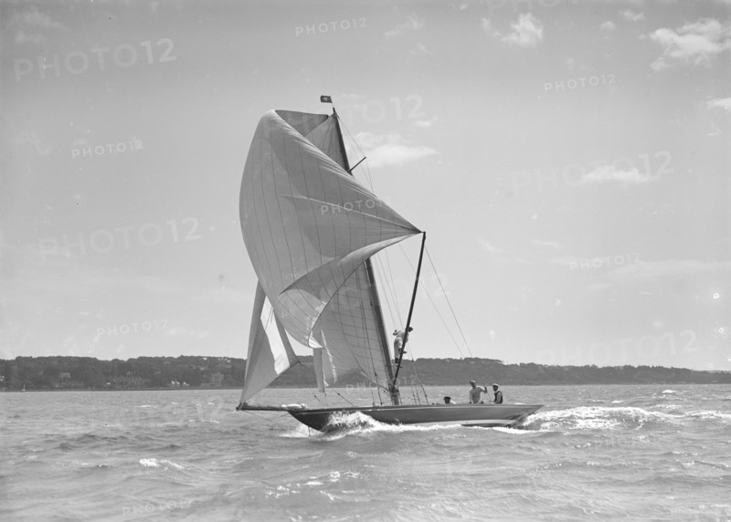 The 8 Metre sailing yacht 'Endrick' sailing downwind under spinnaker, 1911. Creator: Kirk & Sons of Cowes.