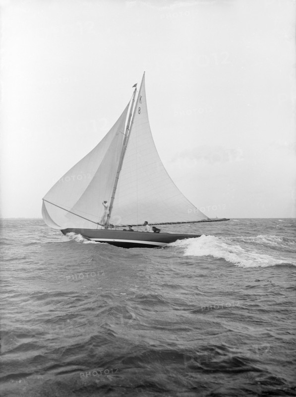 The 7 Metre yacht 'Pinaster' (K8) sailing with spinnaker, 1913. Creator: Kirk & Sons of Cowes.