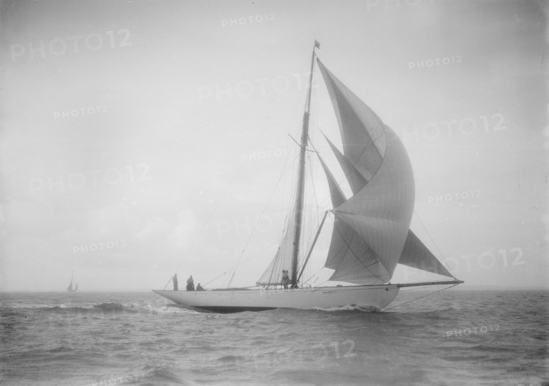 The cutter 'Westwind' sailing with spinnaker, 1912. Creator: Kirk & Sons of Cowes.