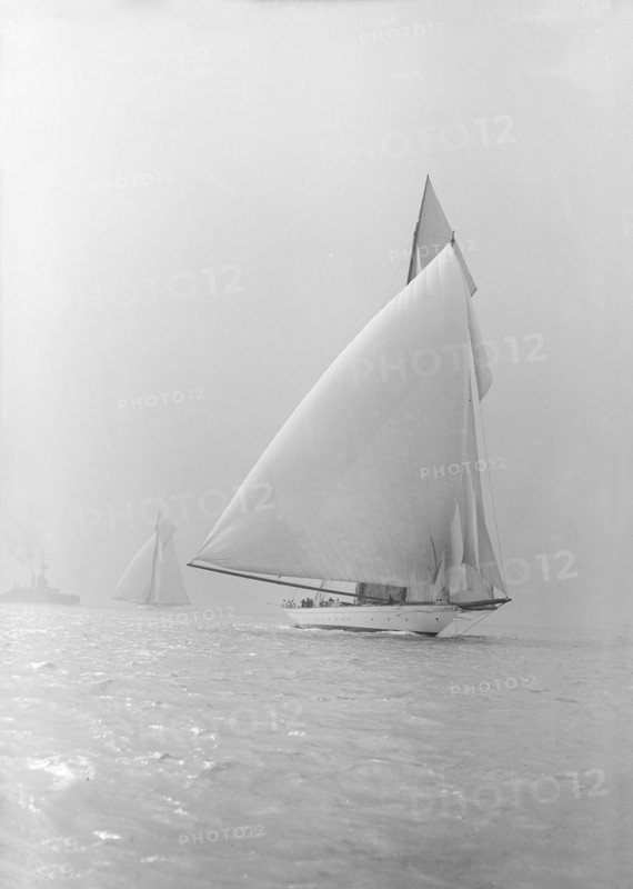 The 250 ton schooner 'Germania' running under spinnaker, 1913. Creator: Kirk & Sons of Cowes.