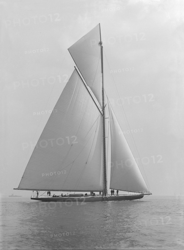 The towering 10,450 sq ft sail area of 'Shamrock IV', 1914. Creator: Kirk & Sons of Cowes.