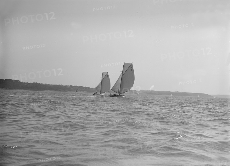 The 8 Metre sailing yachts 'Endrick' and 'Spero' racing downwind, 1911. Creator: Kirk & Sons of Cowes.