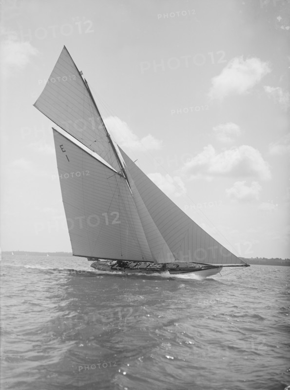 The 12 Metre yacht 'Alachie' makes swift progress upwind, 1911. Creator: Kirk & Sons of Cowes.