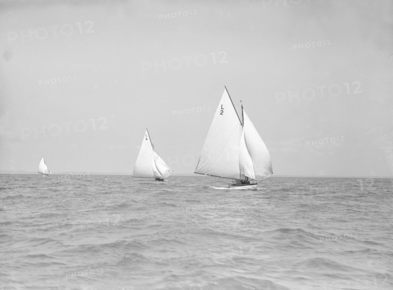 The 6 Metre 'The Whim' (L6) and 'Correnzia' racing downwind, 1911. Creator: Kirk & Sons of Cowes.