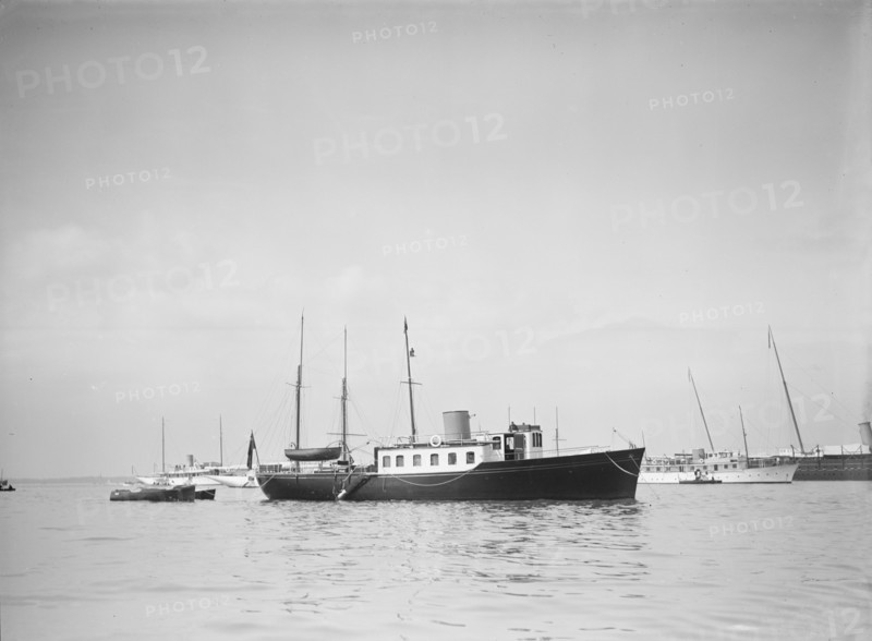 The twin screw 80ft motor yacht 'Bystander' at anchor, 1934. Creator: Kirk & Sons of Cowes.