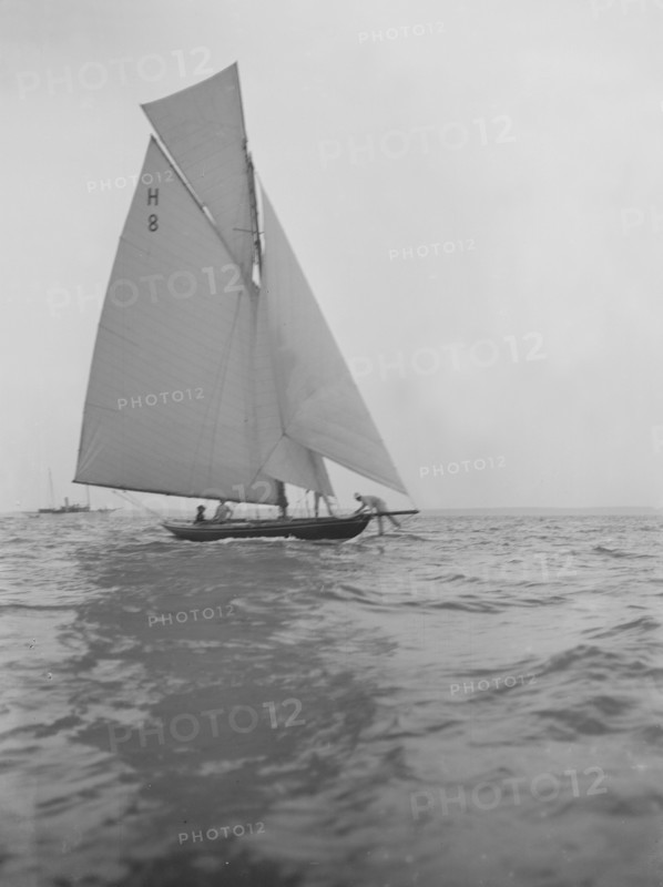 Mrs GA Shenley at the helm of the 8 Metre class sailing yacht 'Spero' (H8). Creator: Kirk & Sons of Cowes.