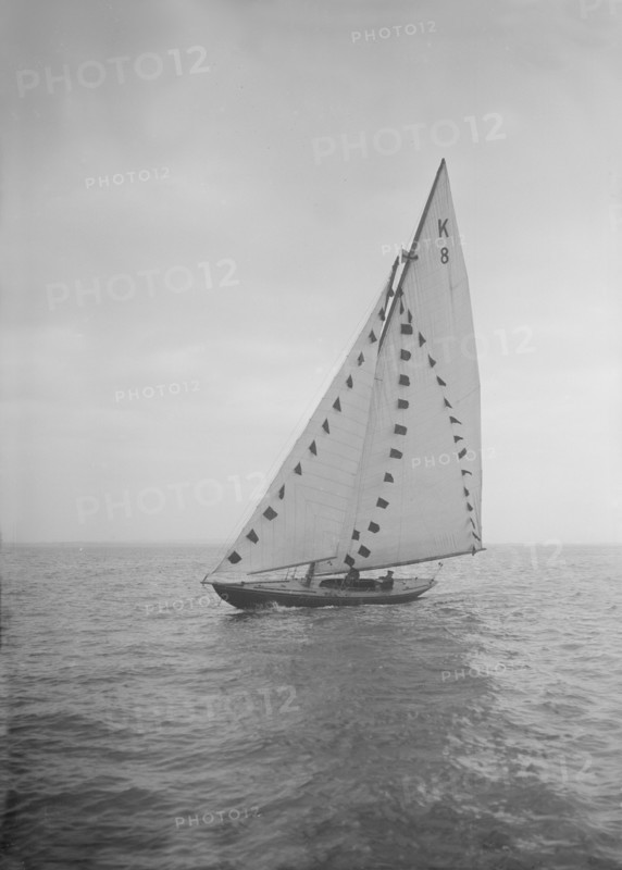 The 7 Metre sailing yacht 'Pinaster' (K8) with prize flags, 1912. Creator: Kirk & Sons of Cowes.