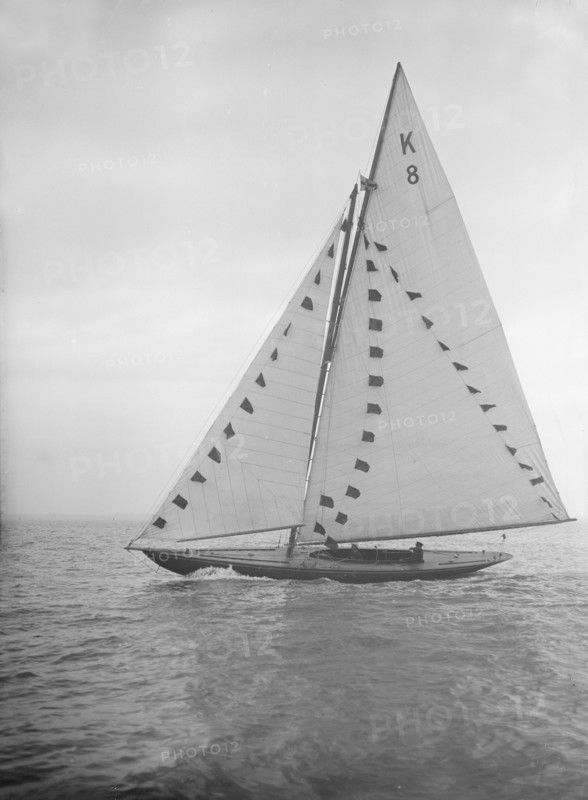 The 7 Metre sailing yacht 'Pinaster' (K8) with prize flags, 1912. Creator: Kirk & Sons of Cowes.