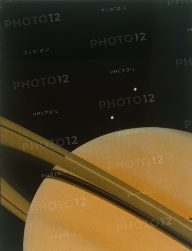 The planet Saturn with moons Tethys and Dione. Creator: NASA.