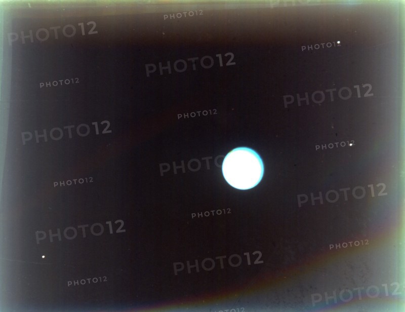 Uranus with satellites Miranda, Ariel and Umbriel, from Voyager 2, 24 January 1986. Creator: NASA.