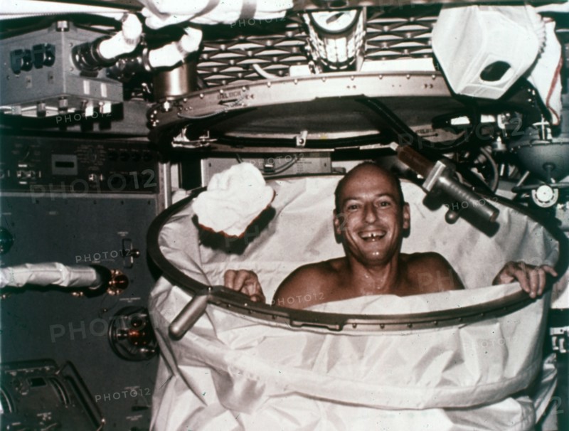 Conrad in shower facility aboard Skylab 2, 1973. Creator: NASA.