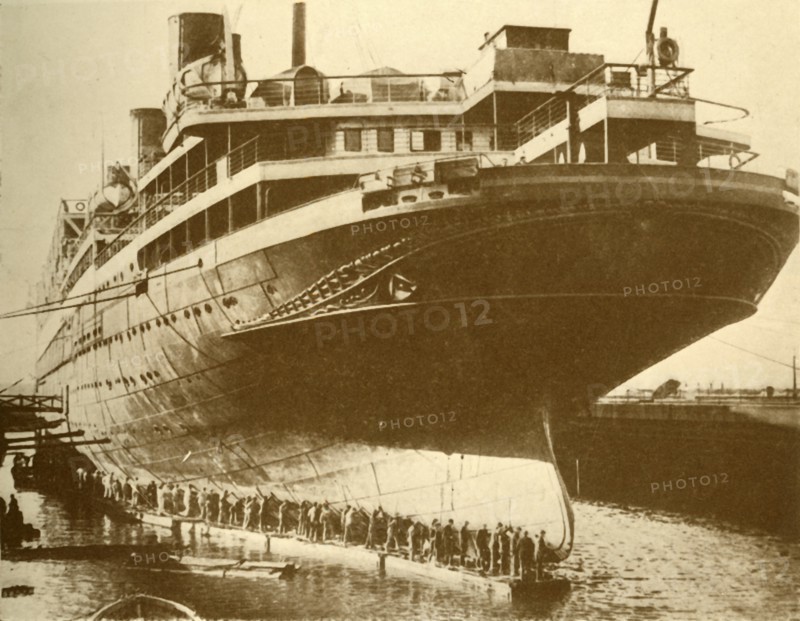 Cleaning the Hull of the "Majestic" in Dry Dock', c1930.