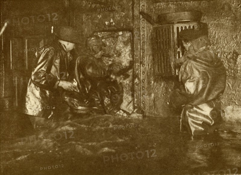 Divers Plugging A Leak During Salvage Operations Waist-Deep In Water On the Lower Decks Of The Germ