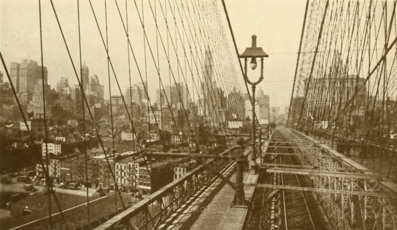 Lower Manhattan Viewed Through The Network Of Cables On Brooklyn Suspension Bridge', c1930.