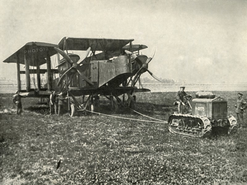 A Small Motor Tractor Getting a Huge R.A.F. Bombing Machine into Position...', (1919).