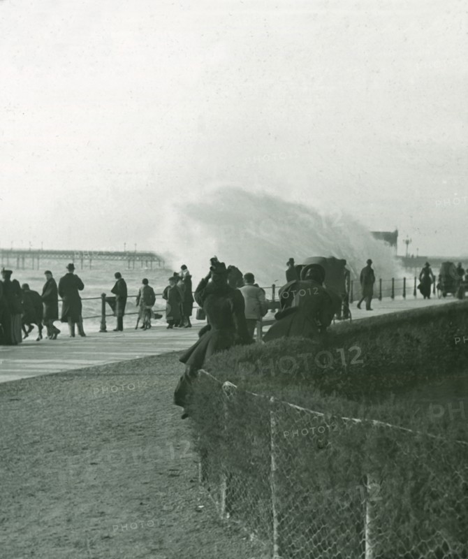Rough sea over the promenade at Hastings, Sussex, late 19th-early 20th century.