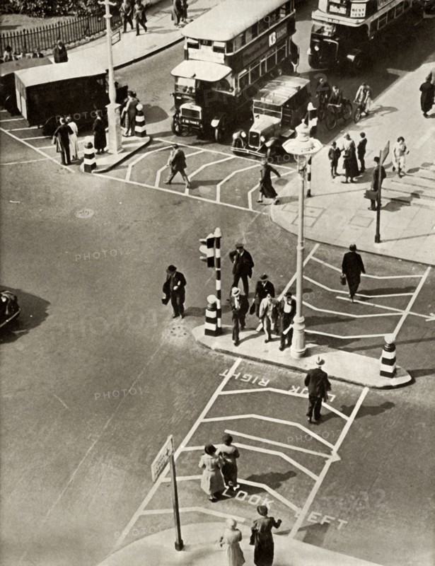 Traffic and pedestrians in Trafalgar Square, London