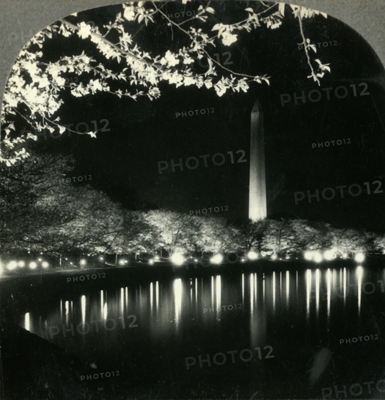 'When It Is Cherry Blossom Time in Washington - A Lovely Night View of Washington Monument', c1930s. Creator: Unknown.