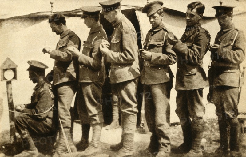 British soldiers synchronising their watches on the front line, First World War, 1914-1918, (1933). Creator: Unknown.
