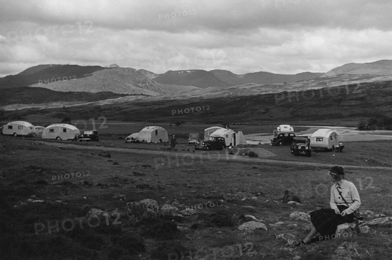 Group of cars and caravans camping in Scottish Highlands 1930's. Creator: Unknown.