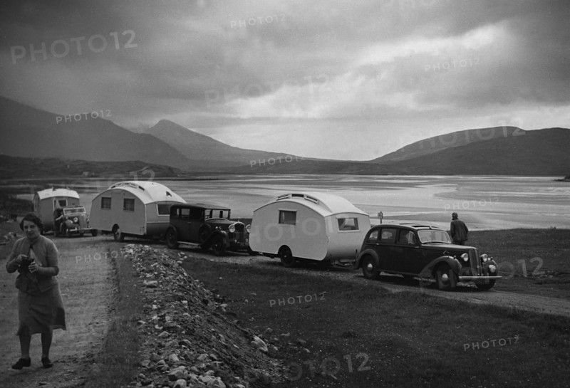 Group of cars and caravans camping in Scottish Highlands 1930's. Creator: Unknown.