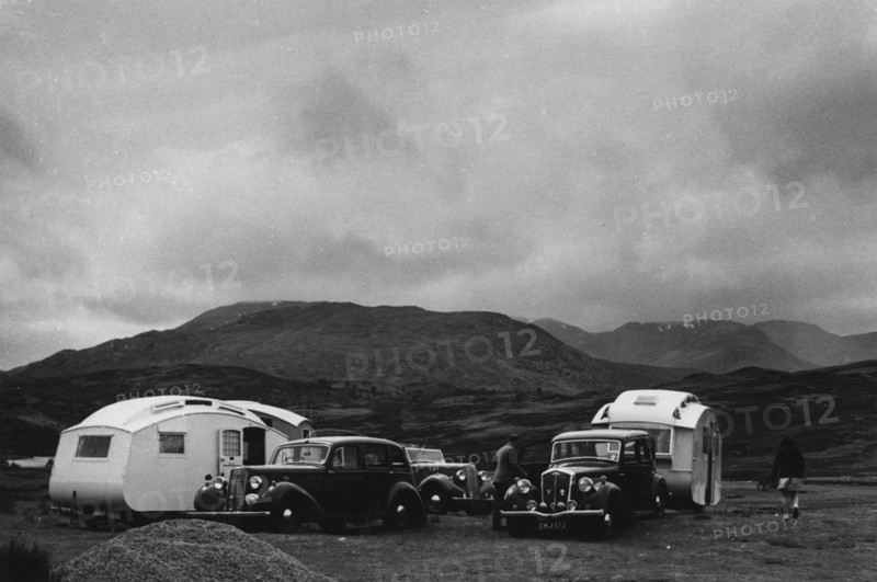 Group of cars and caravans camping in Scottish Highlands 1930's. Creator: Unknown.