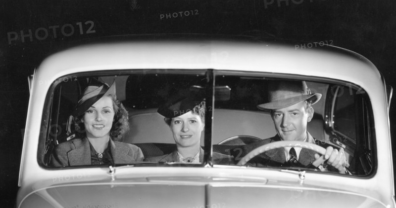 1939 Oldsmobile driver and female passengers. Creator: Unknown.