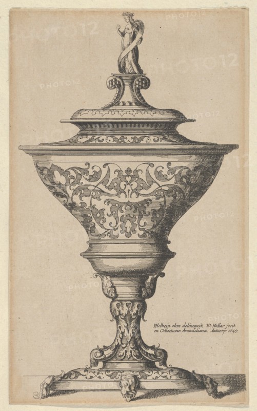 Ornate goblet on feet of masks