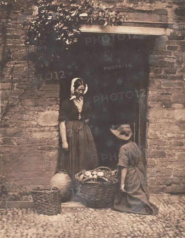 [Two Women, One Kneeling and One Standing, Looking into Basket Filled with Vegetables], 1853-56.