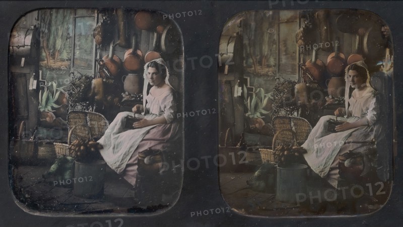 [Woman in Apron and Bonnet Grinding Coffee in Kitchen Setting], 1850s.