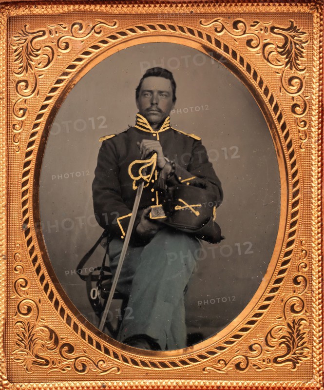 Union Cavalry Officer Displaying Sword, Holding Hat, Seated in Studio, 1861-65.