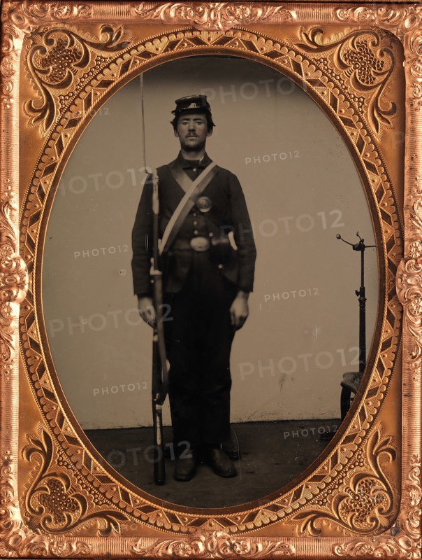 [Union Soldier Holding Rifle, with Photographer's Posing Stand], 1861-65.