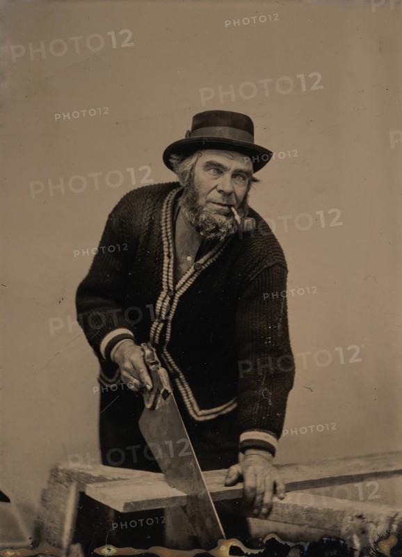 Carpenter Sawing a Plank of Wood, 1880s-90s.