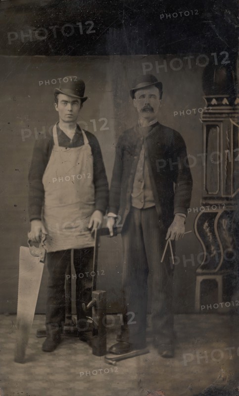 Two Carpenters with a Handsaw, Wood Plane, Hammer, Compass, and Square, 1880s.