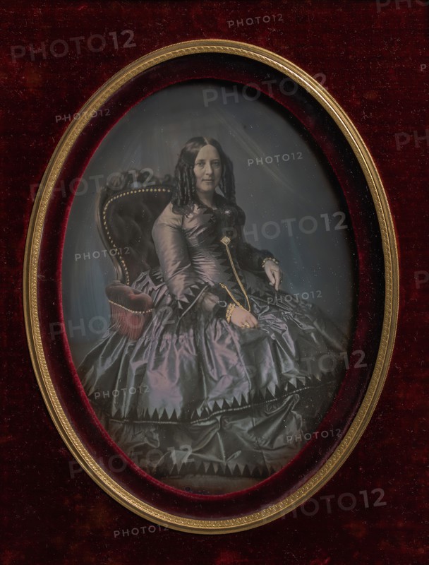 Finely Dressed Woman Seated in Armchair, 1850s.