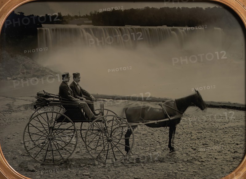 Two Men Seated in a Horse-Drawn Carriage in Front of Niagara Falls, 1860s.