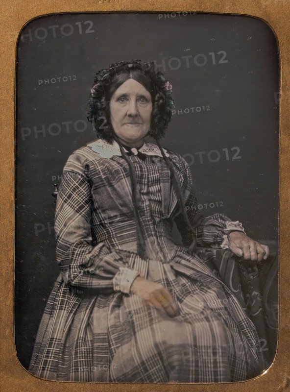 Seated Elderly Woman Wearing Plaid Dress and Bonnet, 1854-60.