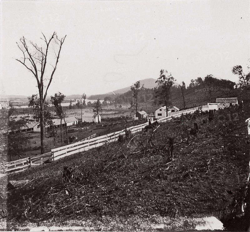 [White picket fence with buildings in background]. Brady album, p. 123, 1861-65. Formerly attributed to Mathew B. Brady.