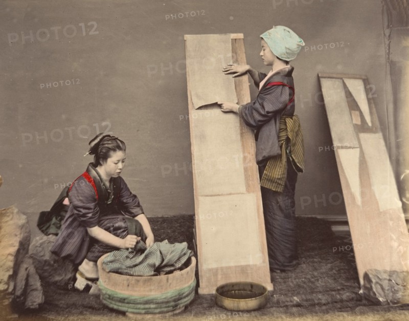 [Two Japanese Women Posing with Laundry], 1870s.