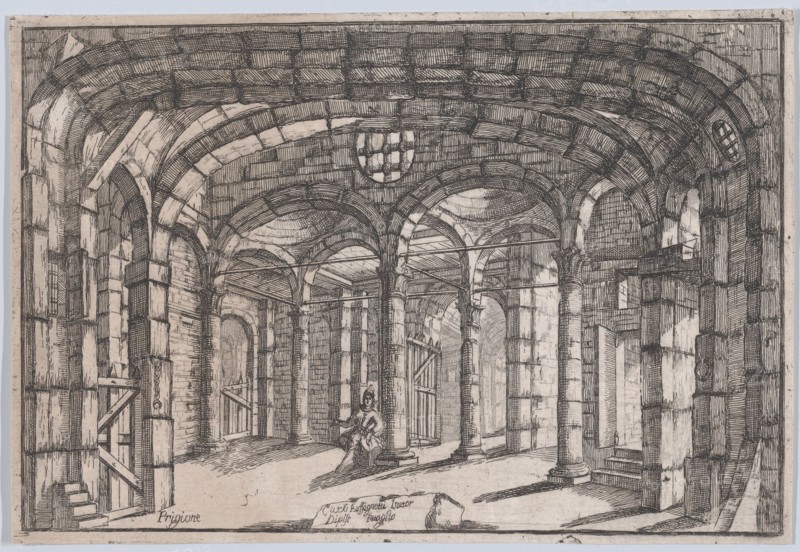 Interior of a prison in which sits a woman