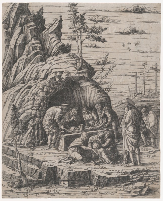 The Entombment of Christ who is being lowered by two men into a stone tomb before...