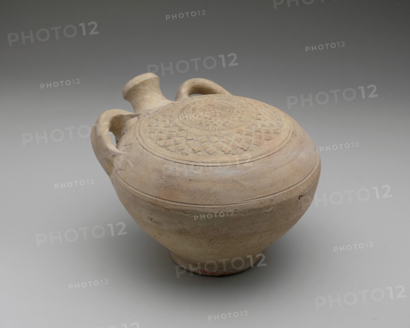 Flask with Molded Decoration, Iran, 12th-13th century. Central medallion the head of a simurgh