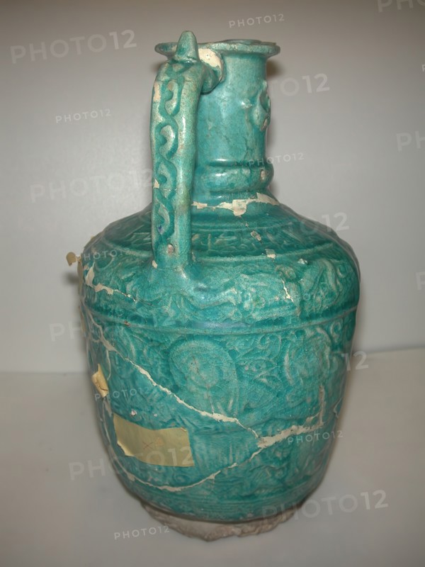 Ewer with Molded Inscriptions, Animals and Dancers, Iran, last quarter 11th or 12th century. Inscription mentions the name of the potter, Abu Ahmad Qassa?i. Choral dances performed at the time included the mystic dances of the Sufi and those related to Zoroastrian worship rituals.