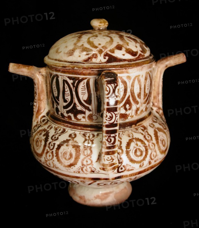 Two-Spouted Vessel with a Lid, Syria or Iran, 12th century. With an inscription in pseudo-kufic script.
